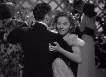 Movie still from “Rebecca” (1940), directed by Alfred Hitchcock – A man and a woman dancing together at a party; Medium shot, Low angle