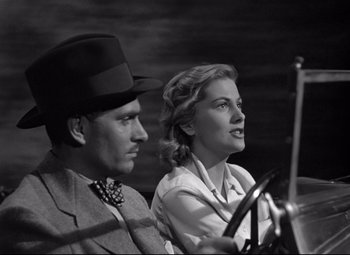 Movie still from “Rebecca” (1940), directed by Alfred Hitchcock – A man and a woman sitting next to each other; Close Up shot, Low angle