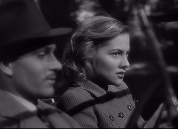 Movie still from “Rebecca” (1940), directed by Alfred Hitchcock – A man and a woman sitting next to each other; Close Up shot, Over the shoulder angle