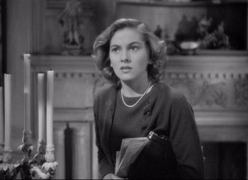 Movie still from “Rebecca” (1940), directed by Alfred Hitchcock – A black - and - white photo of a woman holding a purse; Close Up shot, Over the shoulder angle