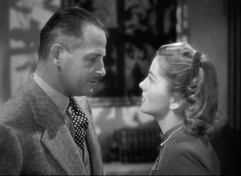 Movie still from “Rebecca” (1940), directed by Alfred Hitchcock – An older man and a younger woman looking at one another; Close Up shot, Low angle