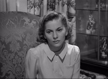 Movie still from “Rebecca” (1940), directed by Alfred Hitchcock – A black - and - white photo of a woman in a dress; Close Up shot, High angle