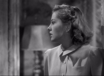 Movie still from “Rebecca” (1940), directed by Alfred Hitchcock – A black and white photo of a woman looking up; Close Up shot, Over the shoulder angle