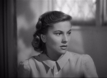 Movie still from “Rebecca” (1940), directed by Alfred Hitchcock – A black - and - white photo of a woman in a dress; Close Up shot, Low angle