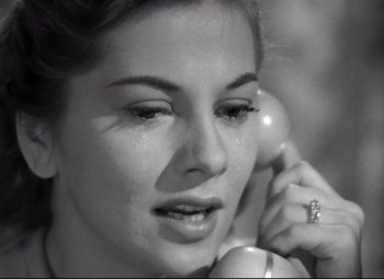 Movie still from “Rebecca” (1940), directed by Alfred Hitchcock – A person talking on a cell phone; Close Up shot, High angle