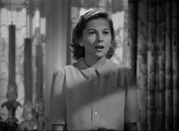 Movie still from “Rebecca” (1940), directed by Alfred Hitchcock – A black - and - white photo of a woman looking at the camera; Close Up shot, Low angle