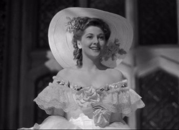 Movie still from “Rebecca” (1940), directed by Alfred Hitchcock – A black and white photo of a woman wearing a hat; Close Up shot, Low angle