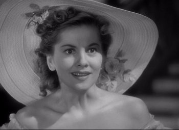 Movie still from “Rebecca” (1940), directed by Alfred Hitchcock – A black and white photo of a woman wearing a hat; Close Up shot, Low angle