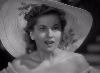 Movie still from “Rebecca” (1940), directed by Alfred Hitchcock – A black and white photo of a woman wearing a sun hat; Close Up shot, High angle