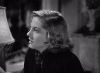 Movie still from “Rebecca” (1940), directed by Alfred Hitchcock – A young woman is looking to her left; Close Up shot, Over the shoulder angle
