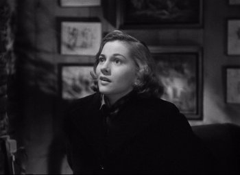 Movie still from “Rebecca” (1940), directed by Alfred Hitchcock – Black and white photograph of a woman in a black jacket; Close Up shot, High angle