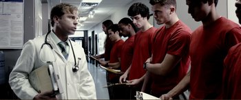 Movie still from “Hostage 911” (2018), directed by Robert Rodriguez – A group of young men standing next to each other in a hallway; Medium shot, Low angle