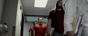 Movie still from “Hostage 911” (2018), directed by Robert Rodriguez – A group of men standing next to each other in a room; Medium shot, Low angle