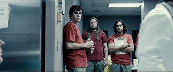 Movie still from “Hostage 911” (2018), directed by Robert Rodriguez – A group of young men standing next to each other in a hallway; Medium shot, Low angle