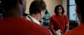 Movie still from “Hostage 911” (2018), directed by Robert Rodriguez – A group of people in a room talking to each other; Medium shot, Over the shoulder angle