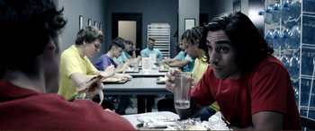 Movie still from “Hostage 911” (2018), directed by Robert Rodriguez – A group of people sitting at a table eating food; Medium shot, Over the shoulder angle