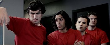 Movie still from “Hostage 911” (2018), directed by Robert Rodriguez – Three young men in red shirts posing for a picture; Close Up shot, Over the shoulder angle