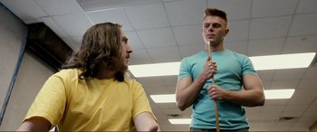 Movie still from “Hostage 911” (2018), directed by Robert Rodriguez – Two young men are talking in a room; Medium shot, Over the shoulder angle