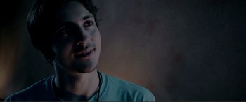 Movie still from “Hostage 911” (2018), directed by Robert Rodriguez – A young man is smiling for the camera; Close Up shot, Low angle