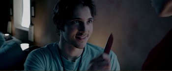 Movie still from “Hostage 911” (2018), directed by Robert Rodriguez – A young man holding a knife in his hand; Close Up shot, Over the shoulder angle