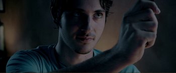 Movie still from “Hostage 911” (2018), directed by Robert Rodriguez – A man's face with his hand raised; Extreme Close Up shot, Low angle