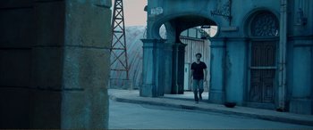 Movie still from “Hostage 911” (2018), directed by Robert Rodriguez – A man is walking through a tunnel in a city; Wide shot, High angle