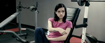 Movie still from “Hostage 911” (2018), directed by Robert Rodriguez – A woman sitting in a chair in a room; Medium shot, High angle