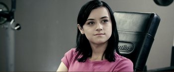 Movie still from “Hostage 911” (2018), directed by Robert Rodriguez – A woman with black hair wearing a pink shirt; Close Up shot, High angle