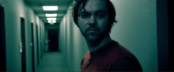 Movie still from “Hostage 911” (2018), directed by Robert Rodriguez – A person in a room; Close Up shot, Low angle