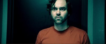 Movie still from “Hostage 911” (2018), directed by Robert Rodriguez – A person wearing a red shirt; Close Up shot, Overhead angle