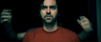 Movie still from “Hostage 911” (2018), directed by Robert Rodriguez – A person wearing a red shirt; Close Up shot, Overhead angle