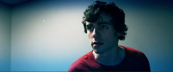 Movie still from “Hostage 911” (2018), directed by Robert Rodriguez – A young man is looking into the distance; Close Up shot, Low angle