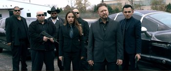 Movie still from “Hostage 911” (2018), directed by Robert Rodriguez – A group of men and women standing next to each other; Medium shot, Over the shoulder angle