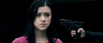 Movie still from “Hostage 911” (2018), directed by Robert Rodriguez – A woman holding a gun in front of her face; Close Up shot, Over the shoulder angle