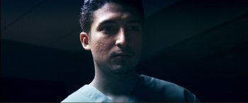 Movie still from “Hostage 911” (2018), directed by Robert Rodriguez – A person wearing a blue shirt; Close Up shot, Low angle