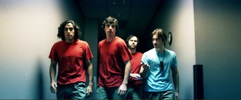 Movie still from “Hostage 911” (2018), directed by Robert Rodriguez – A group of young men standing next to each other in a hallway; Medium shot, Low angle