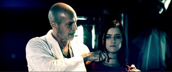 Movie still from “Hostage 911” (2018), directed by Robert Rodriguez – An older man and a young woman in a dark room; Close Up shot, Over the shoulder angle