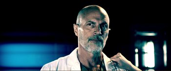 Movie still from “Hostage 911” (2018), directed by Robert Rodriguez – An older man with a beard and a white shirt; Close Up shot, Low angle