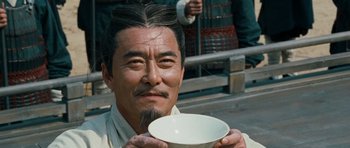Movie still from “Red Cliff” (2008), directed by John Woo – A man holding a white bowl in his hands; Close Up shot, Low angle