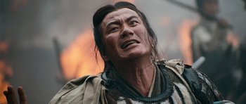 Movie still from “Red Cliff” (2008), directed by John Woo – A man with long black hair and a beard; Close Up shot, Low angle