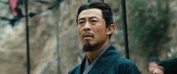 Movie still from “Red Cliff” (2008), directed by John Woo – A man with a long black hair and a beard; Close Up shot, Low angle