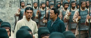 Movie still from “Red Cliff” (2008), directed by John Woo – A group of men standing next to each other in front of each other; Medium shot, Over the shoulder angle