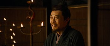 Movie still from “Red Cliff” (2008), directed by John Woo – A man in a black robe is looking at the camera; Close Up shot, Over the shoulder angle