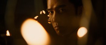 Movie still from “Red Cliff” (2008), directed by John Woo – A man's face in front of a candle; Close Up shot, Low angle