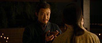 Movie still from “Red Cliff” (2008), directed by John Woo – A man holding a bowl in front of another man; Close Up shot, Over the shoulder angle