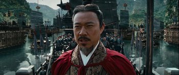 Movie still from “Red Cliff” (2008), directed by John Woo – A man with a long beard and a red cape; Close Up shot, Over the shoulder angle
