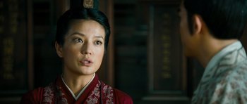 Movie still from “Red Cliff” (2008), directed by John Woo – A woman wearing a red dress and a black hat; Close Up shot, Low angle