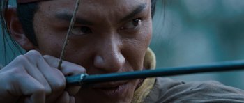Movie still from “Red Cliff” (2008), directed by John Woo – A person holding a stick in his mouth; Extreme Close Up shot, Low angle