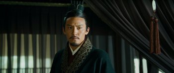 Movie still from “Red Cliff” (2008), directed by John Woo – A man in a black robe and a black hat; Close Up shot, Low angle
