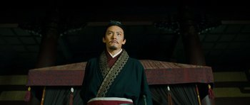 Movie still from “Red Cliff” (2008), directed by John Woo – A man wearing a black robe and a red and black hat; Medium shot, Low angle